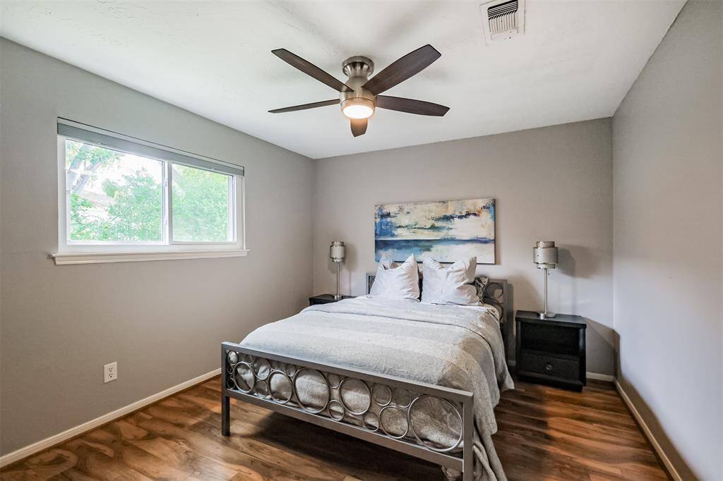 The second bedroom has laminate floors, an updated ceiling fan and walk-in closet.