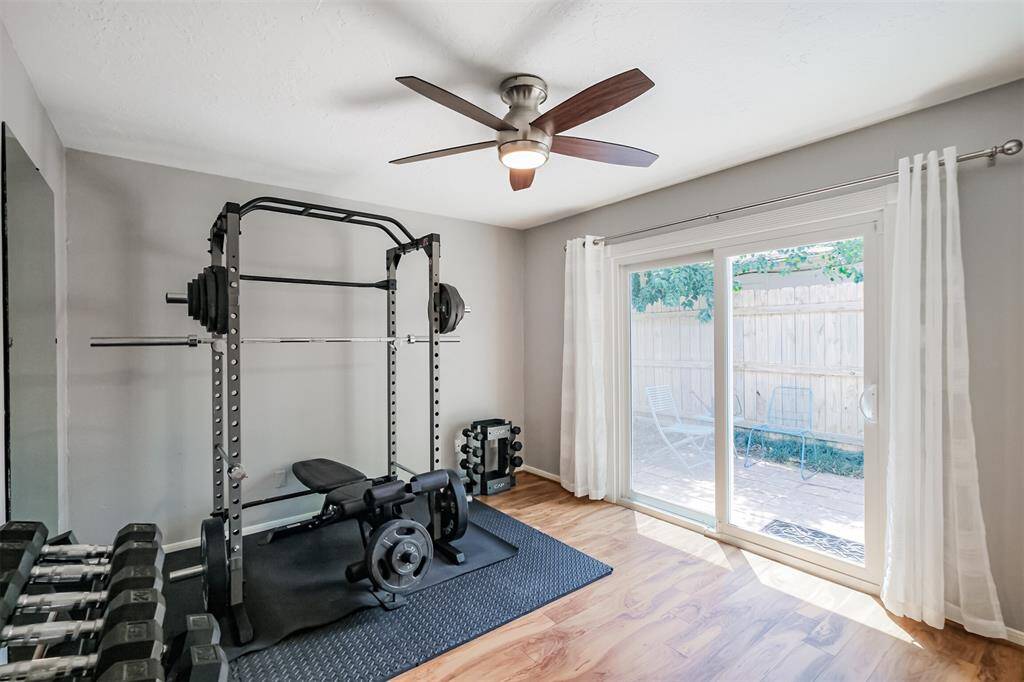 The third bedroom has laminate floors, updated ceiling fan and a double pane sliding glass door to access the side patio.