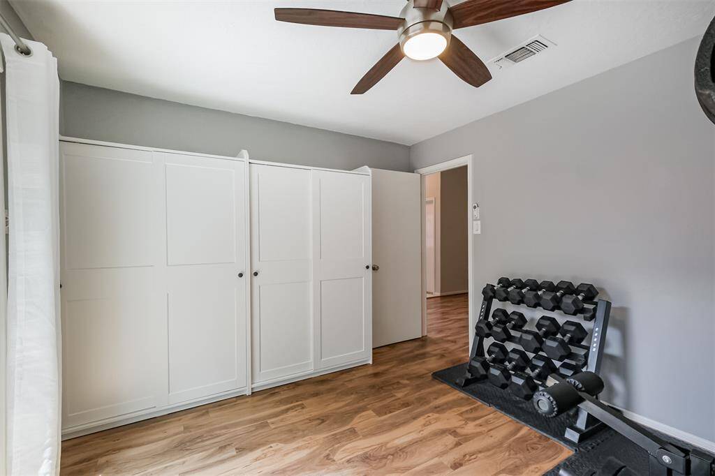 Another view of the third bedroom showcases the built-in closets.