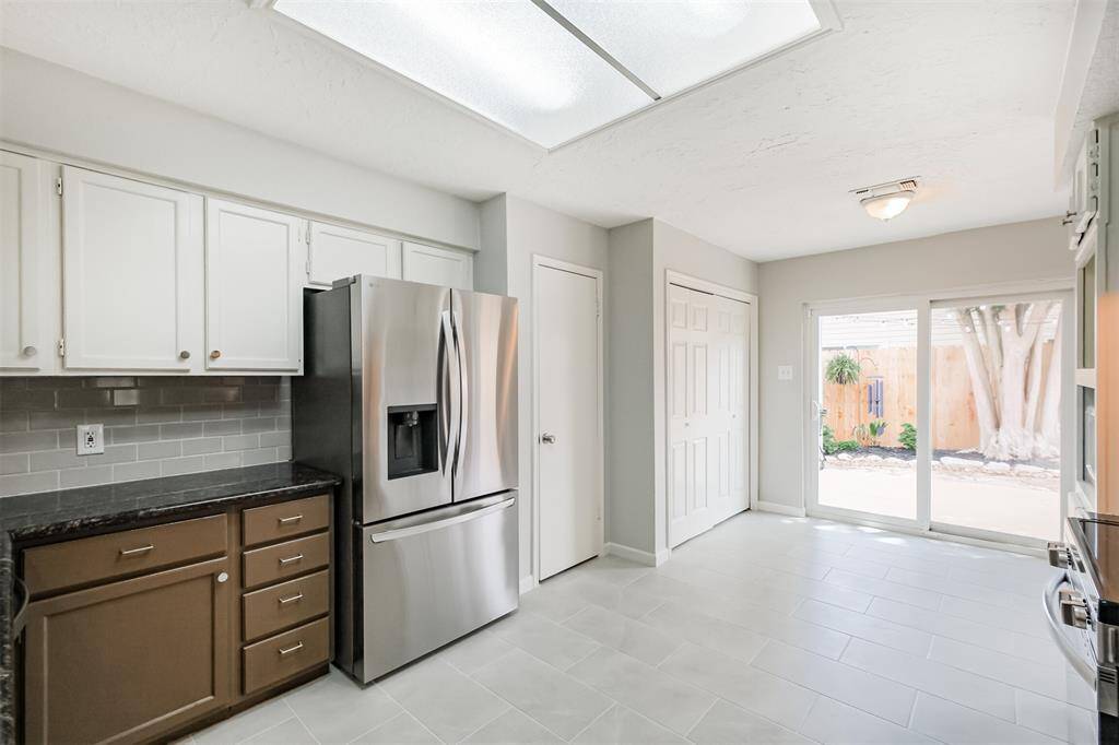 The utility closet is located in the doors closest to the double pane sliding glass door.