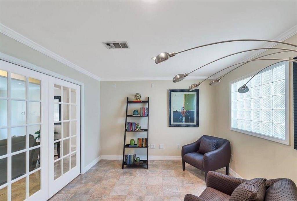 Reading or TV room with double french pocket door.