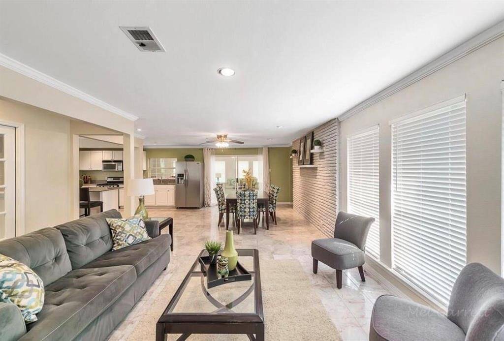 Living Room flows right into the open Dining Room and Sun Room.