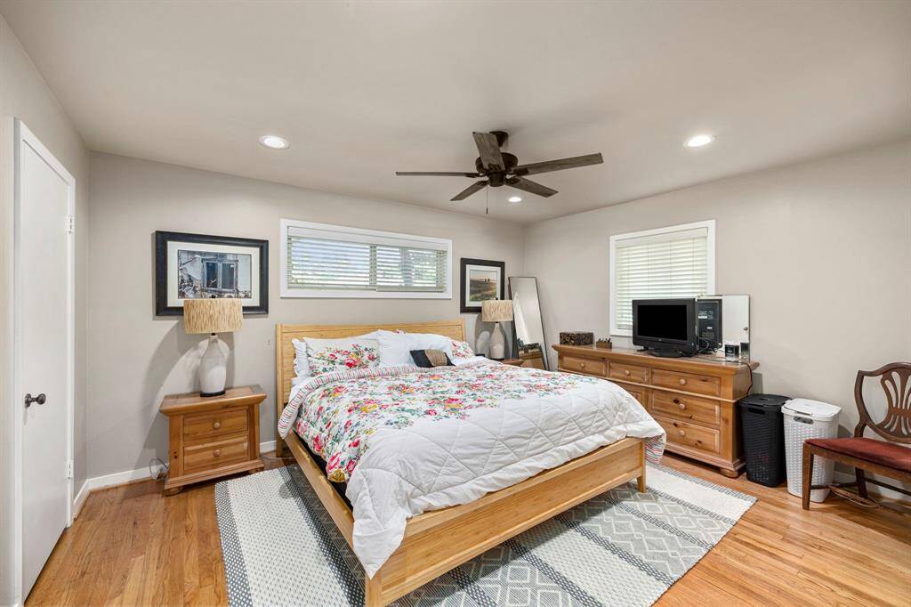 Primary Bedroom has stunning wood floors & updated lighting/fixtures.