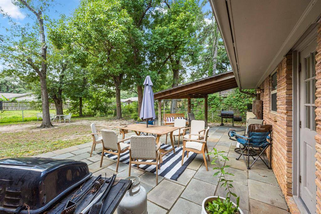 Massive Patio w/ partial coverage & many trees to provide shade. No neighbors directly behind.