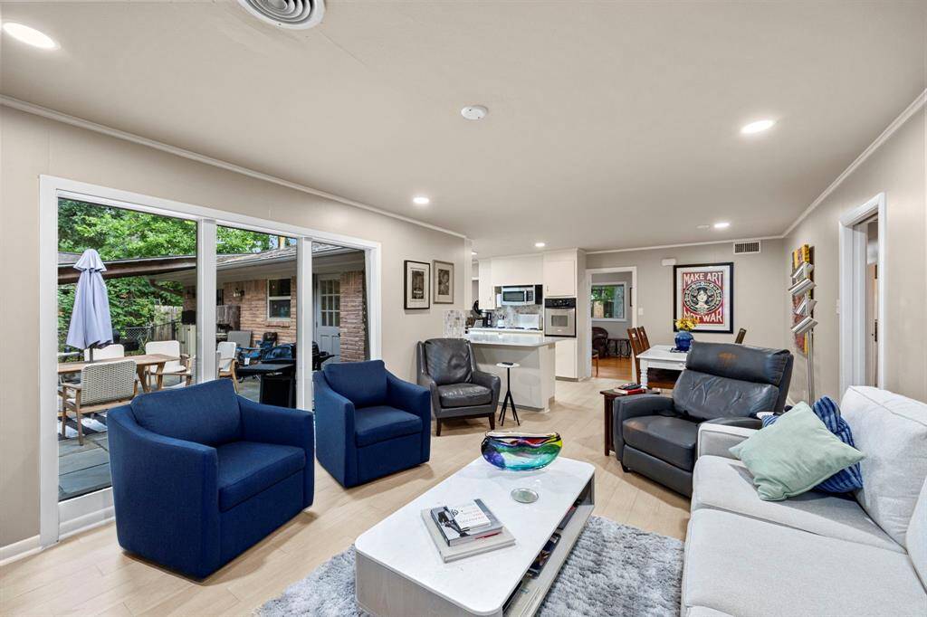 Family Room offers new floors & a wall of windows looking out to the back yard.