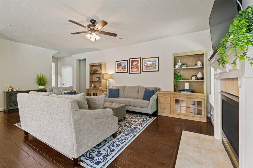 The rich hardwoods lead you into a spacious family room with open sightlines to the kitchen and breakfast area.
