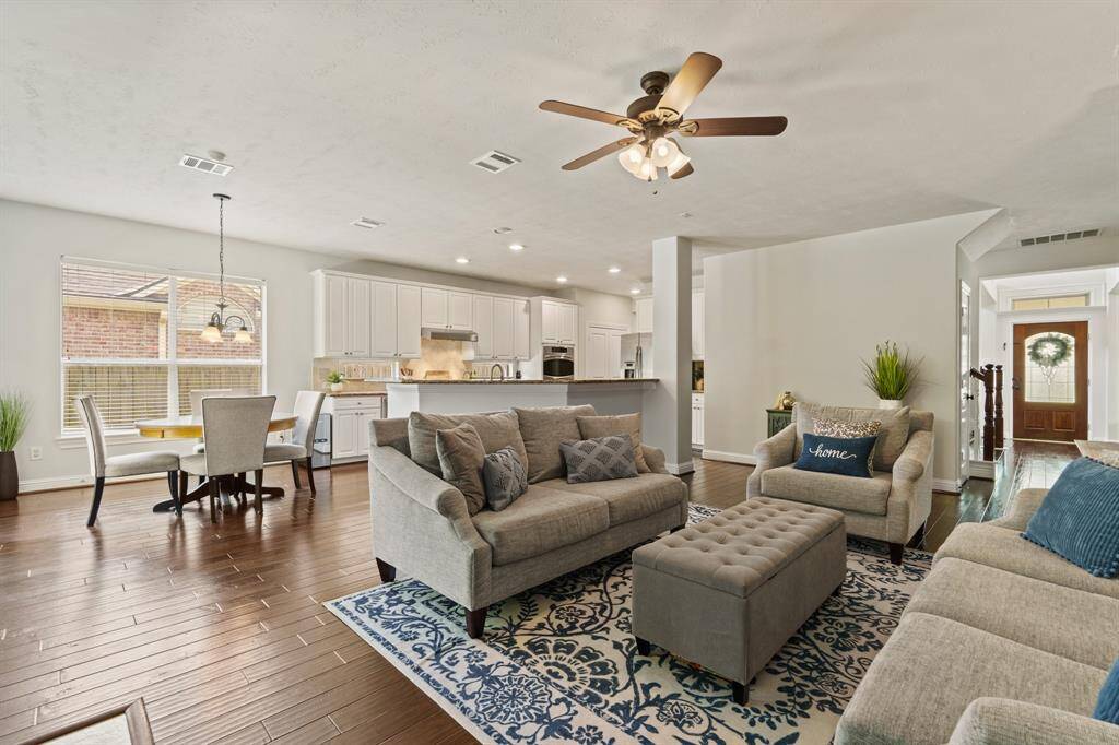 Tall windows, a cozy fireplace, and elegant mantle create a warm and welcoming family room—perfect for relaxing.