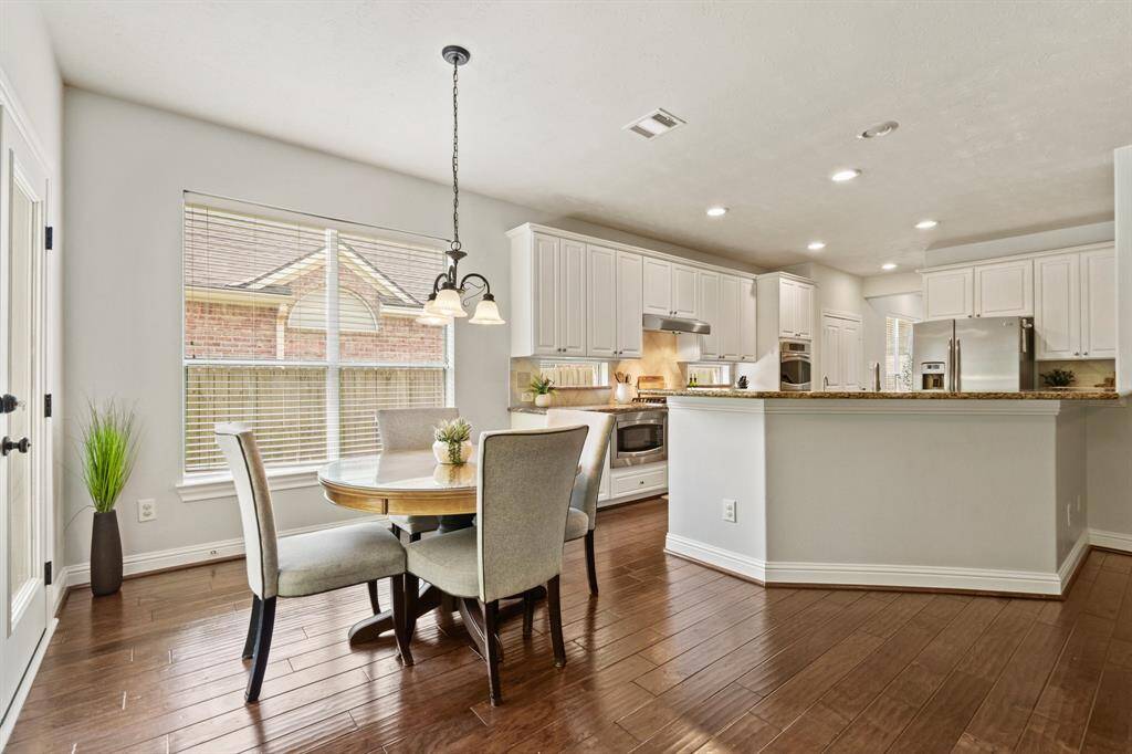 The sunny breakfast nook is ideal for casual meals—enjoy peaceful views of the private backyard with no rear neighbors.