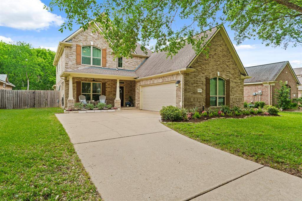 Look at the beautiful and lush landscaping of this home in the private, gated community of Orchard Lake Estates!