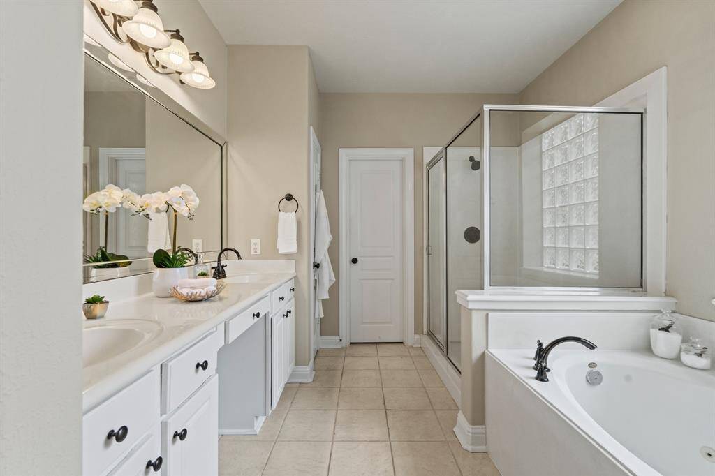 The spa-inspired ensuite bath is bright, airy, and thoughtfully designed with upscale touches.