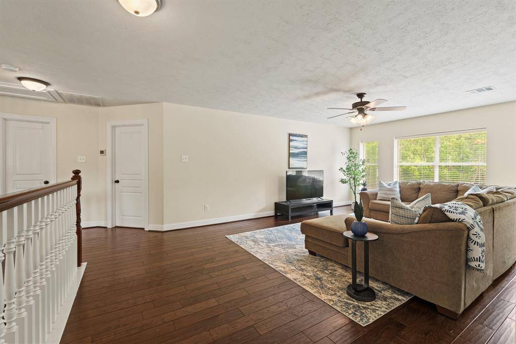Upstairs, a generously sized game room awaits—perfect for movie nights, playtime, or teen hangouts.