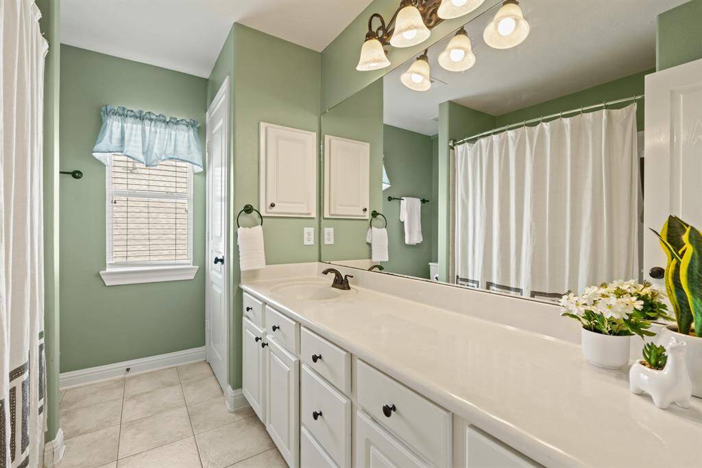 A shared bathroom serves bedrooms 2 and 3 with ease—featuring a tub/shower combo and plenty of storage.