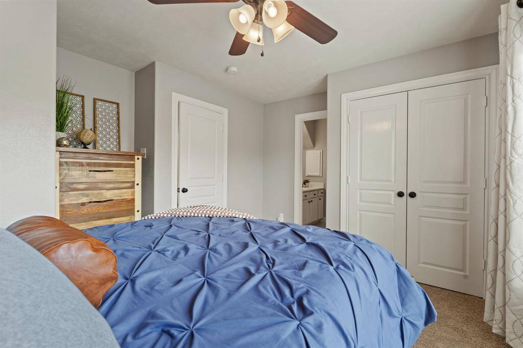 This fourth bedroom is spacious and versatile with a large closet and separation from the other rooms.