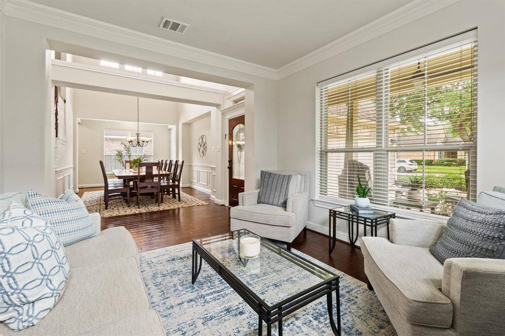The bright and spacious formal living room offers flexibility—use it as a stylish sitting room or a home office.