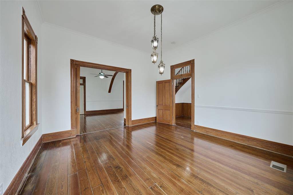 Bright, spacious back room with charming historic wood paneling and ample natural light.