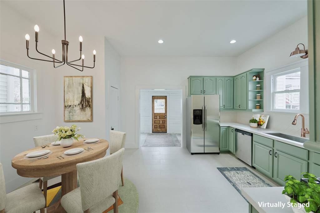 Secondary bathroom has been completely renovated and boasts an attractive double vanity, tilting mirrors, and an impressive shower.