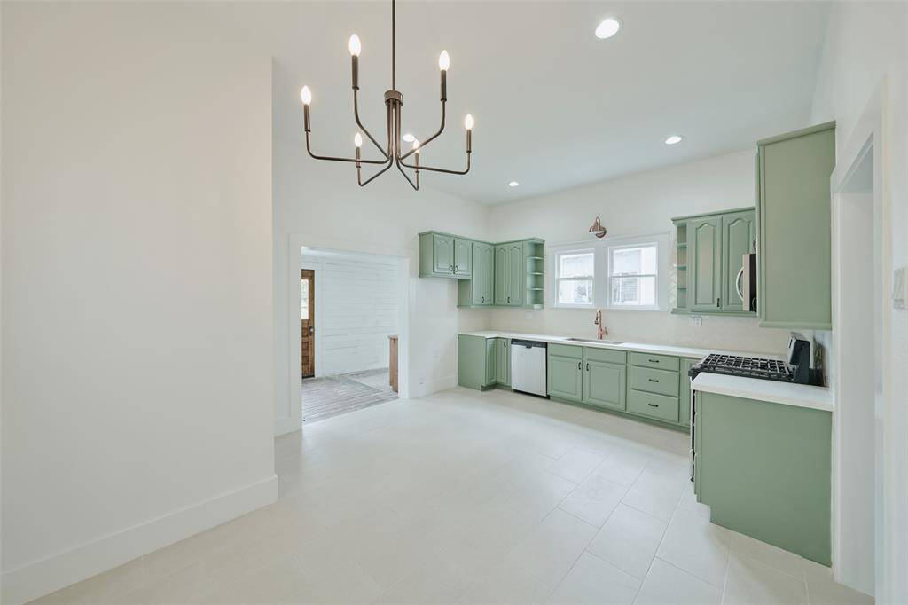 Elegant tile shower featuring an iridescent pebble floor and sleek sliding glass door.