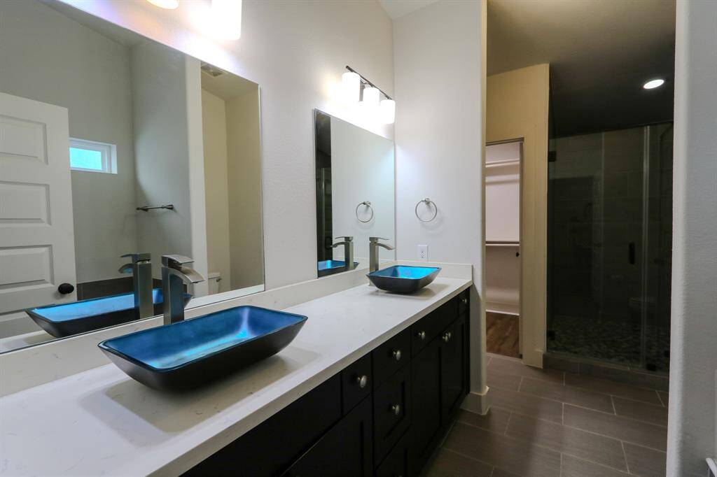 Primary bathroom with duo vanities, separate shower place & a garden tub.