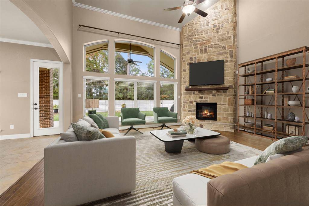 The living room boasts a grand stone fireplace with gas logs reaching to the ceiling."Virtual Staged"