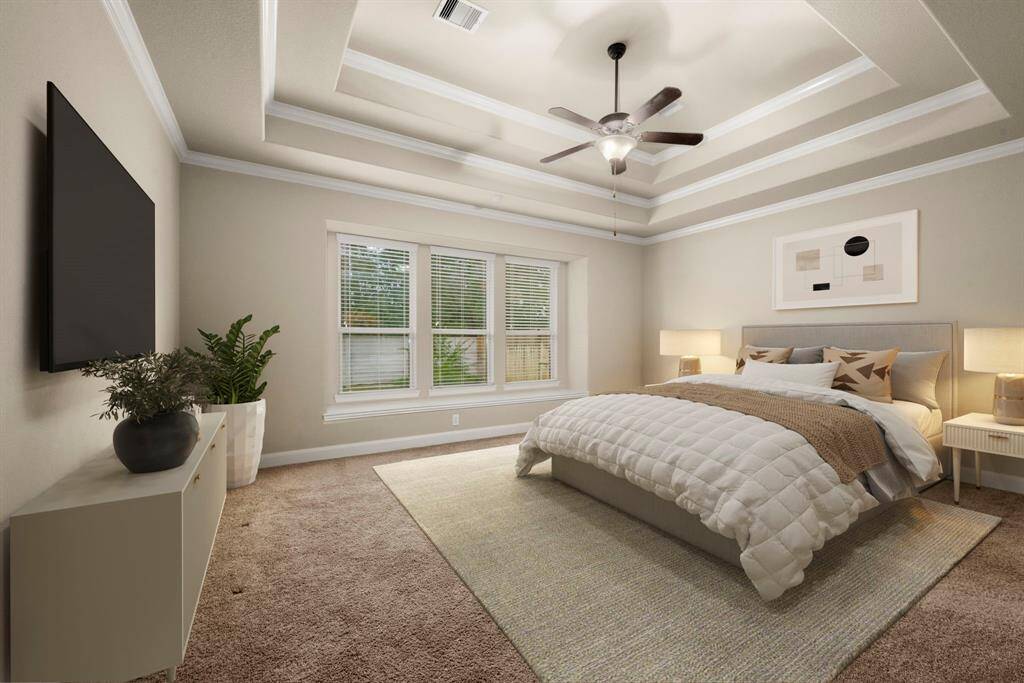 Spacious primary suite with freshly cleaned carpet and sun-filled windows overlooking the tranquil backyard.