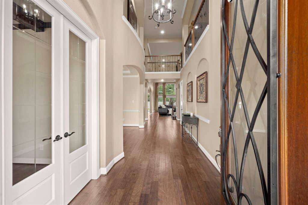 Grand entrance with a long entryway leading to a stunning staircase, setting the stage for elegance.
