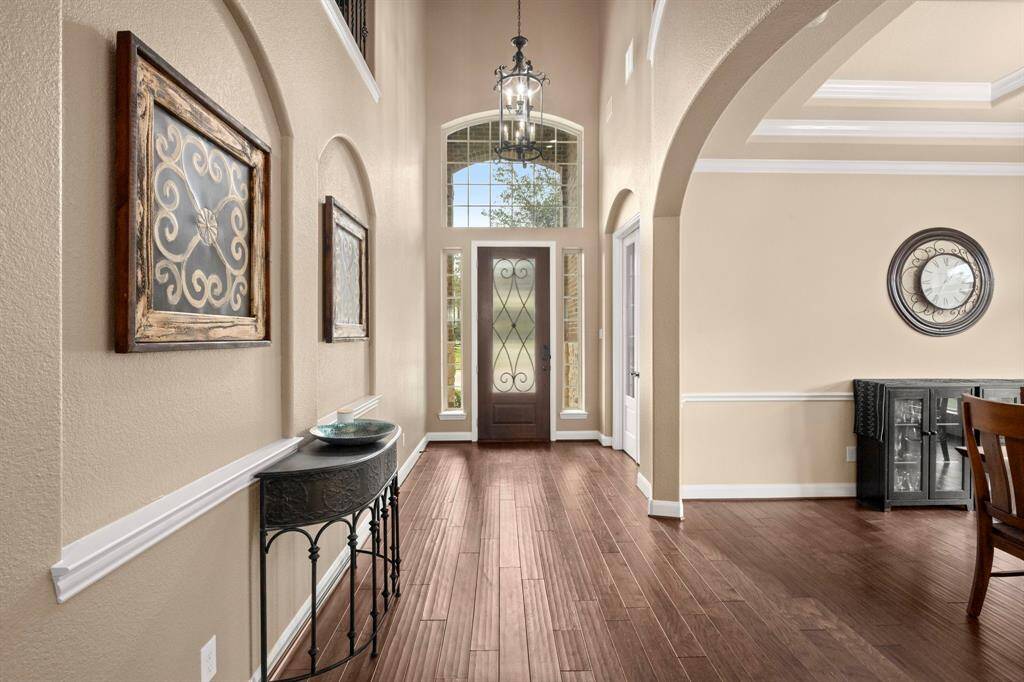 Looking towards the front door you will find the beautiful arched artistic designs placed throughout the home.