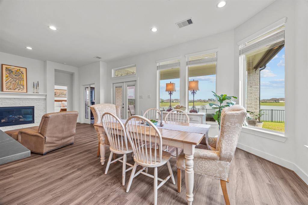 Bright and inviting open-plan living area featuring a dining space with large windows offering scenic views.