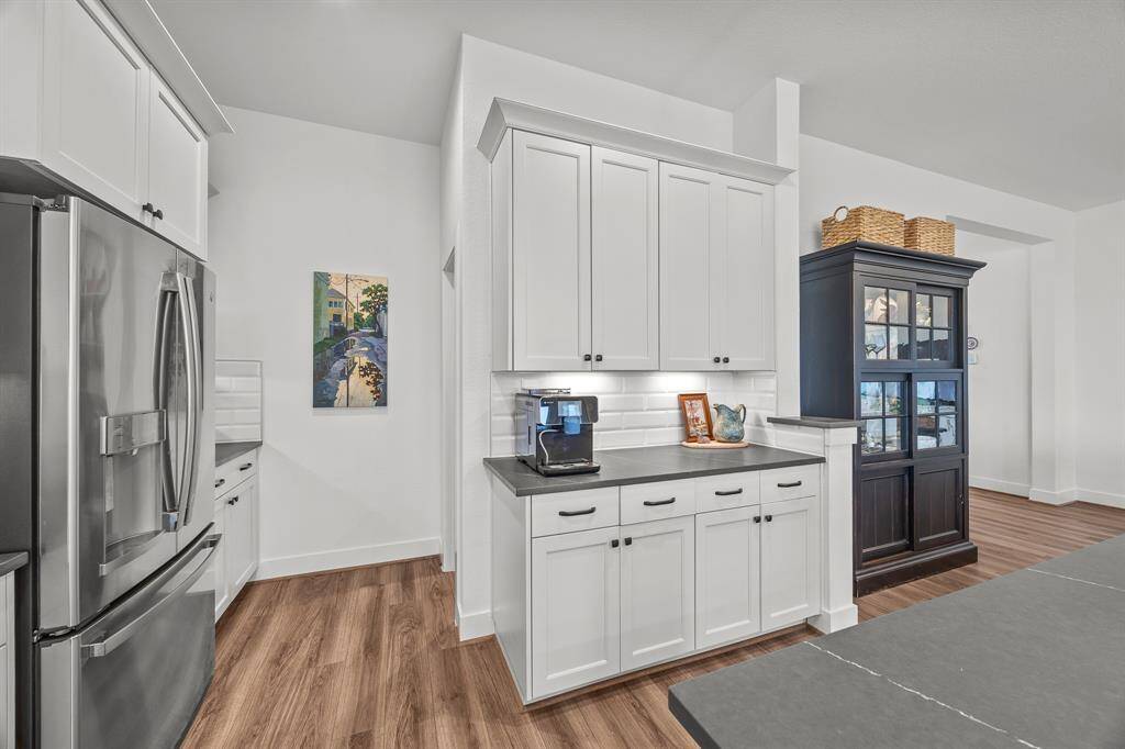 This kitchen offers versatile spaces perfect for a coffee bar or a dedicated baking area for the family chef.