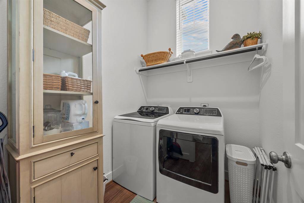 Spacious laundry room with abundant natural light and convenient storage shelf.
