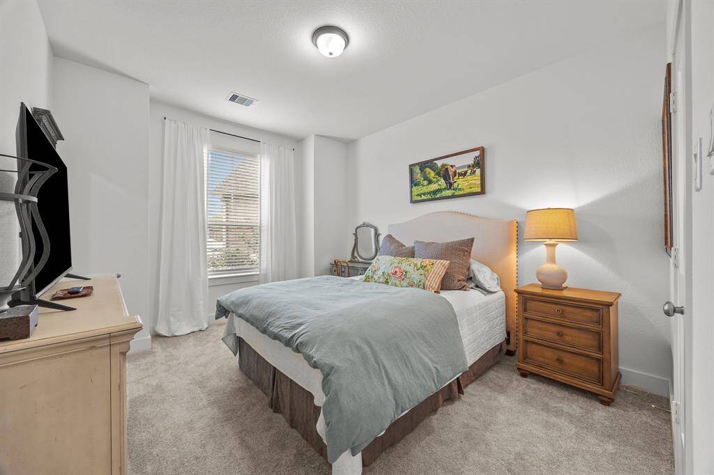 Spacious second bedroom perfect for versatile family needs.
