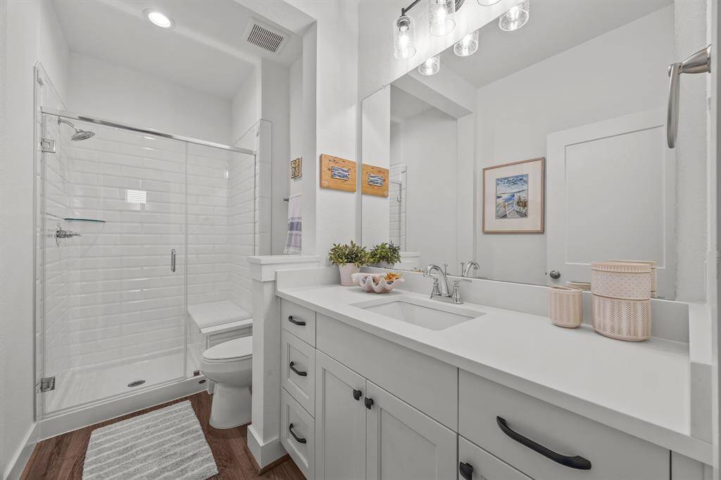 Hall bathroom with lots of storage and a walk in shower