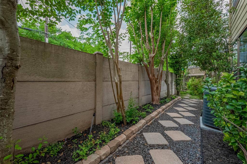 Beautiful walkway that leads you to the back door and downstairs living room.