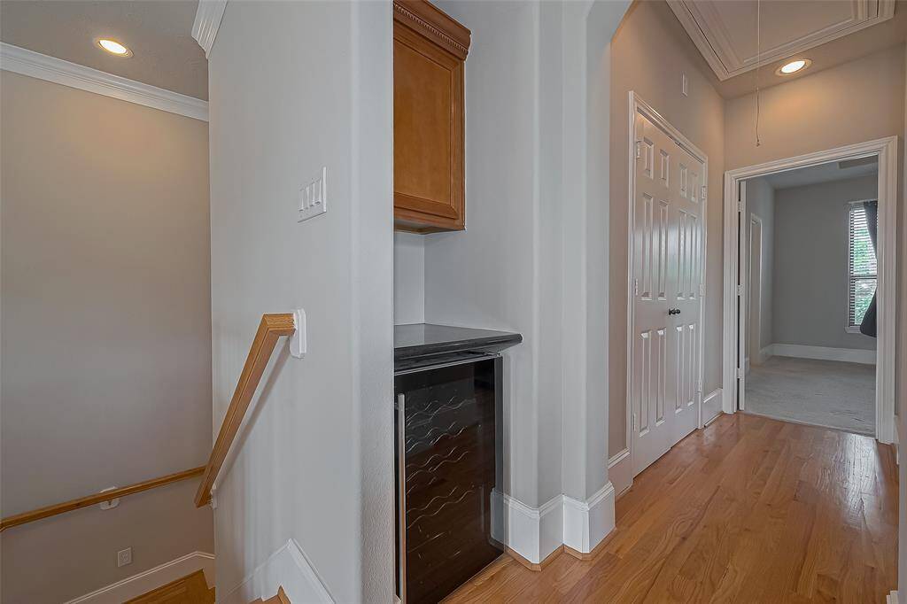 Wine fridge and pantry located directly next to the kitchen upstairs.