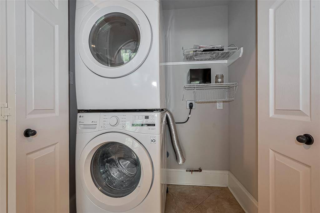 Utility room located downstairs. Washer and dryer included, which can be stacked (as is) or put side by side.