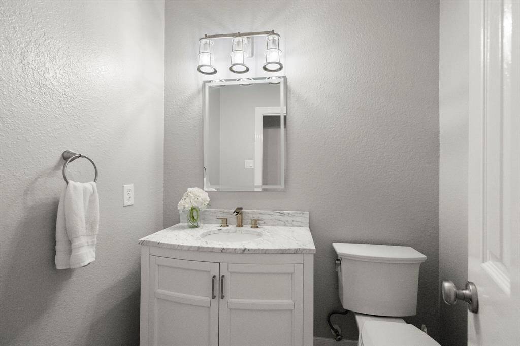 Nicely updated half bath adjacent to the kitchen.