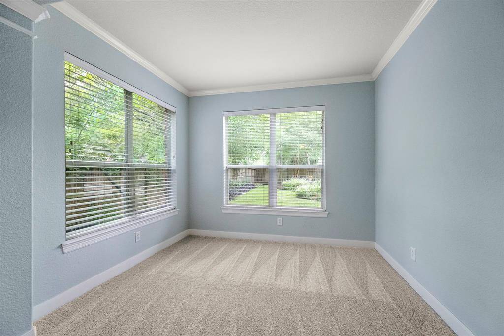Primary bedroom sitting area that is perfect for morning coffee.  The large windows offer a beautiful view of the backyard.
