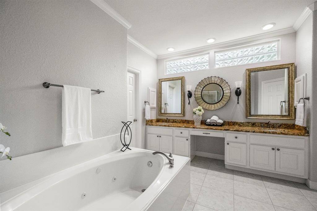 This bathroom features ample natural light from the high windows. Perfect for a luxurious and relaxing experience.