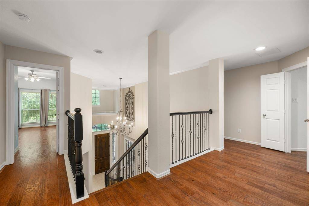 As you walk up the stairs, you will see the bright and open hallway with warm hardwood floors and elegant iron railing. With the majority of the upstairs having hardwood flooring, it makes for easy maintenance.