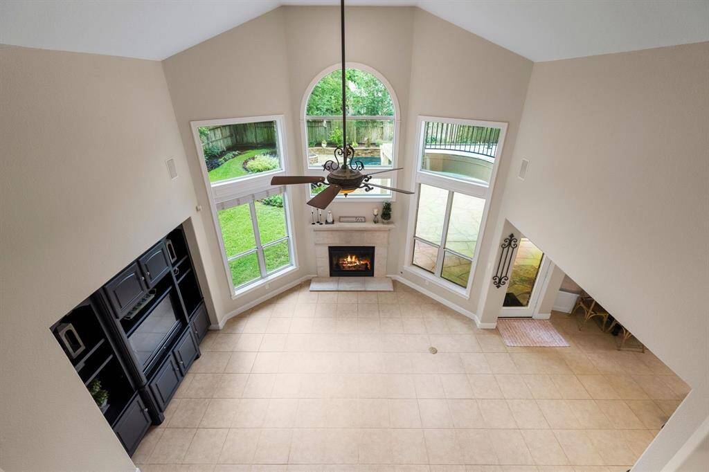 Another view of the spacious family room and large windows showcasing the gorgeous backyard.