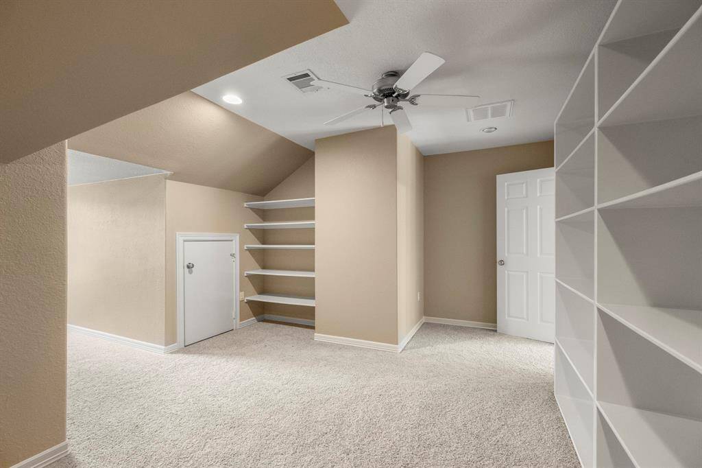 Another view of upstairs flex room that could also be an additional private office or craft room. The built-in shelving is great for storing arts/crafts, toys or office supplies.