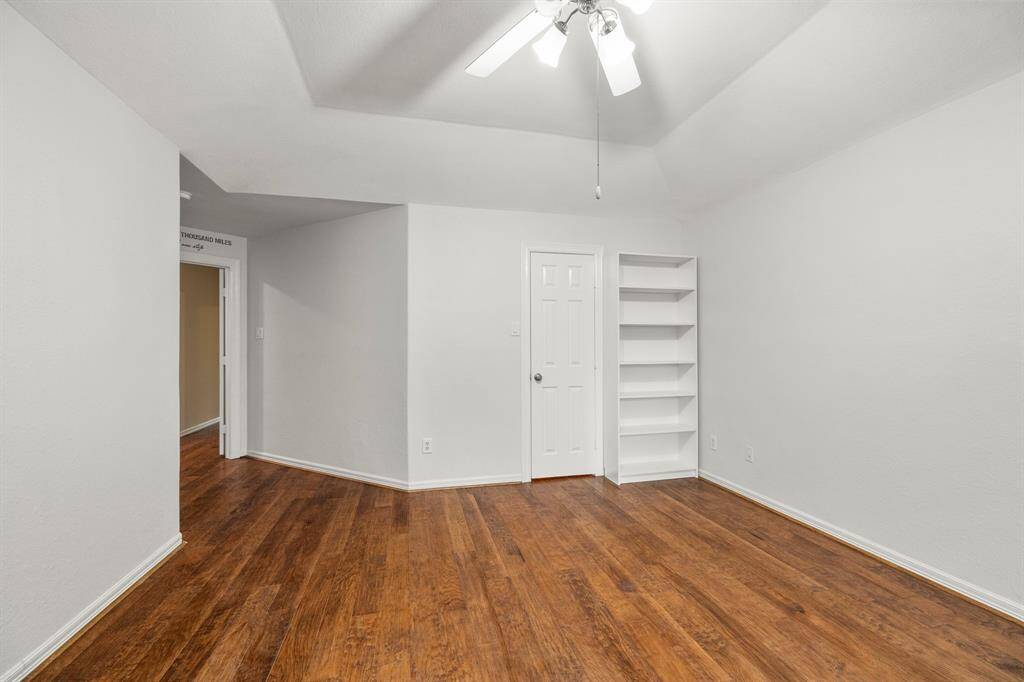 Second bedroom upstairs with a recessed ceiling, hardwood floors and walk in closet.