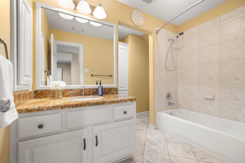 Secondary hall bath with granite and oversized tub/toilet area.