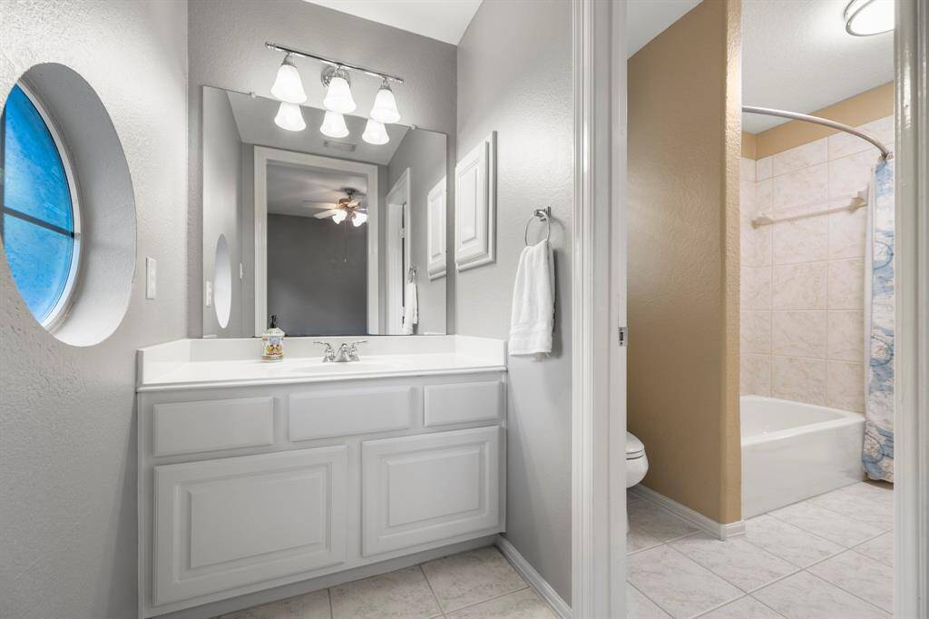Light and bright vanity area of the fifth bedroom with a window to the left.