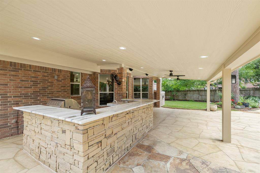 Stacked stone outdoor kitchen and bar that is ideal for entertaining.