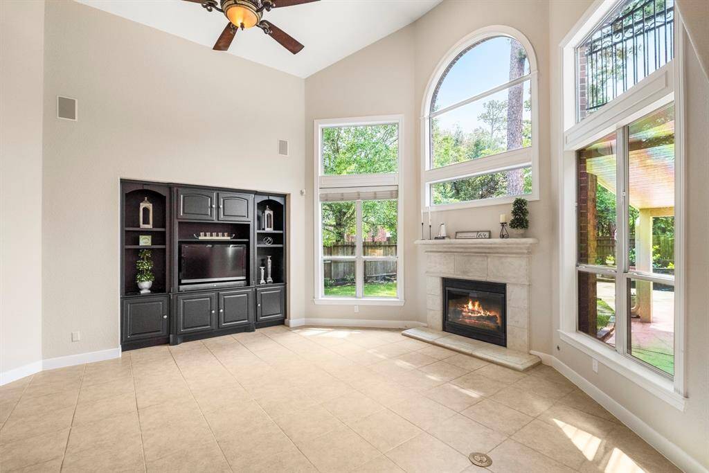 High ceilings and large windows bring in lots of natural light. The fireplace adds warmth and ambiance.