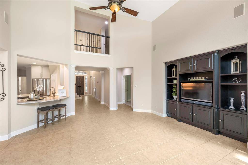 The spacious layout includes a view of the kitchen's breakfast bar that is open to the family room.