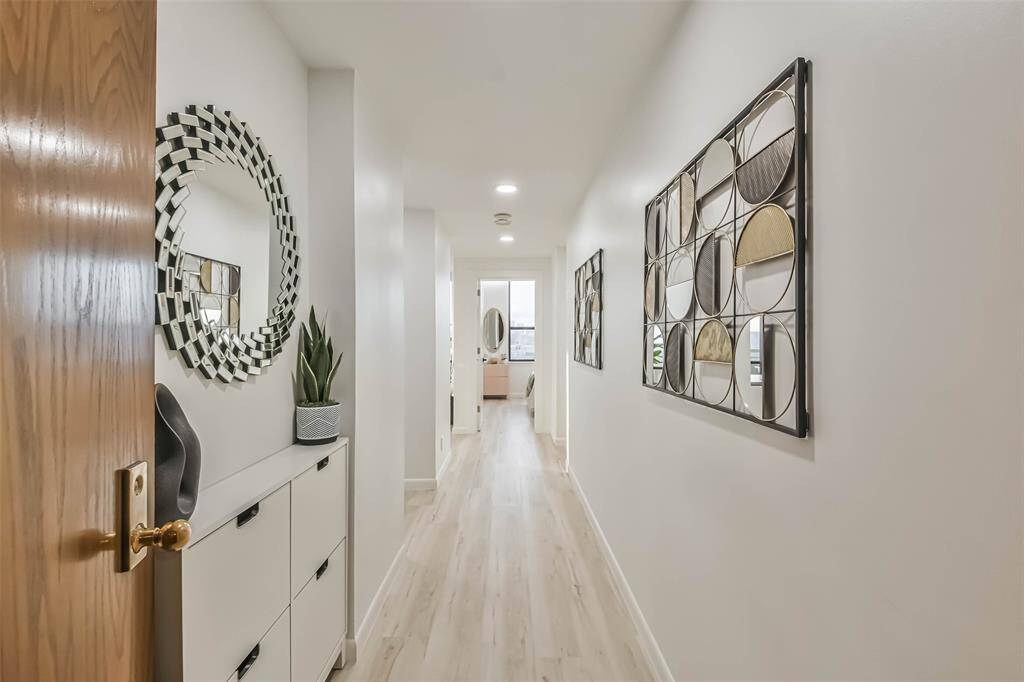 The beautful entry opens to this masterful renovation of the 1681 square foot corner unit that was completed in 2024.