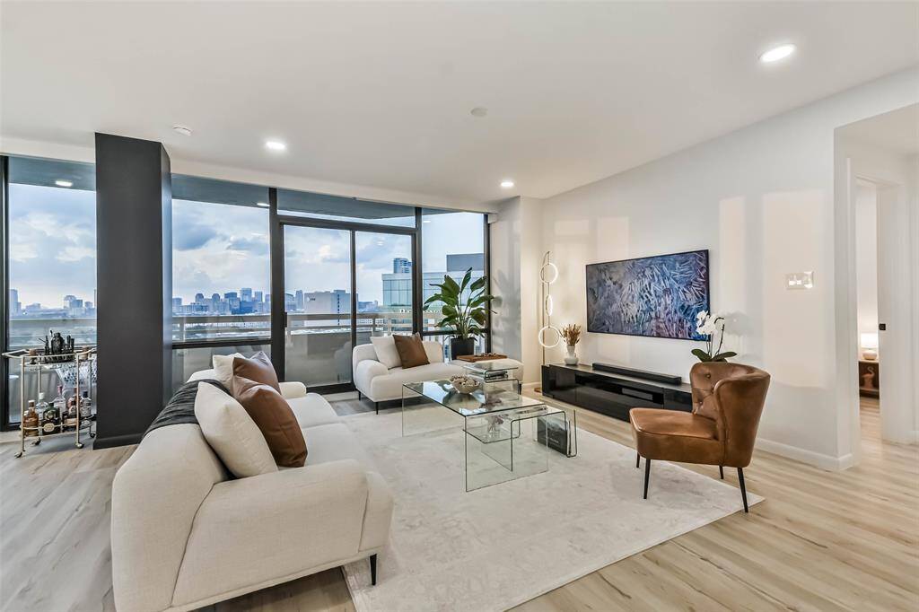 The lovely living area is a comfortable tv spot. Lighting throughout has multiple settings from bright light to dusk. Additionally, all of the windows are framed by light .