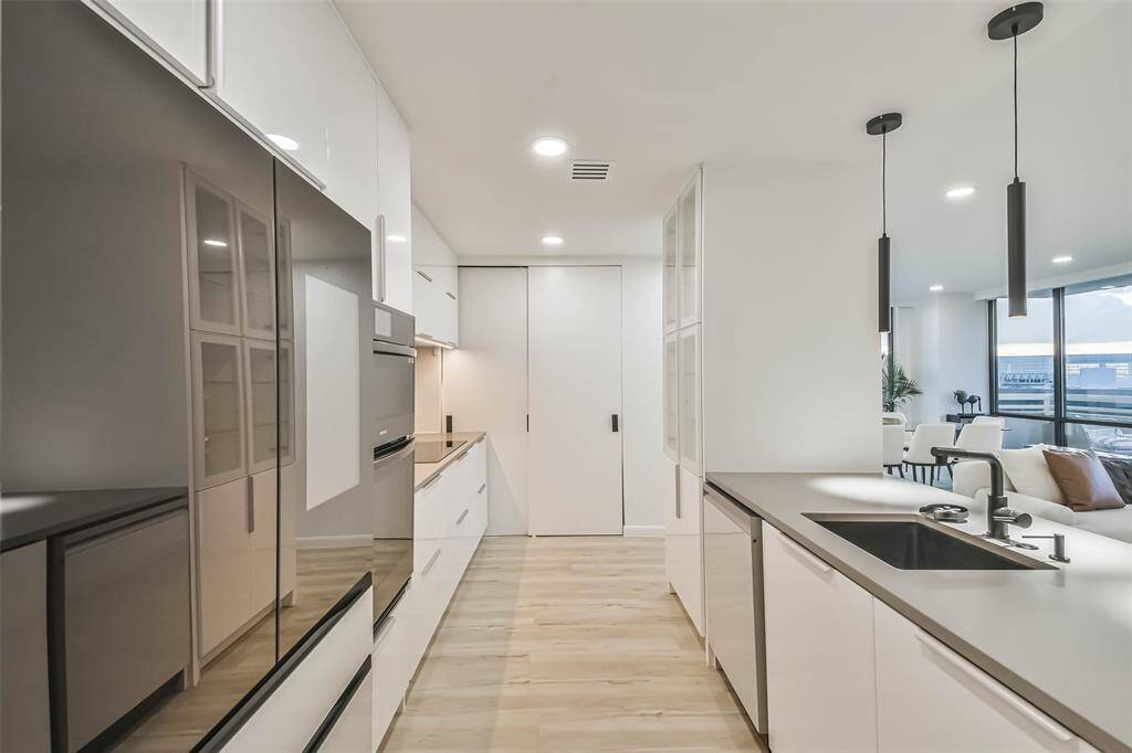 This is a view of the sleek kitchen back toward sliding door pantry.