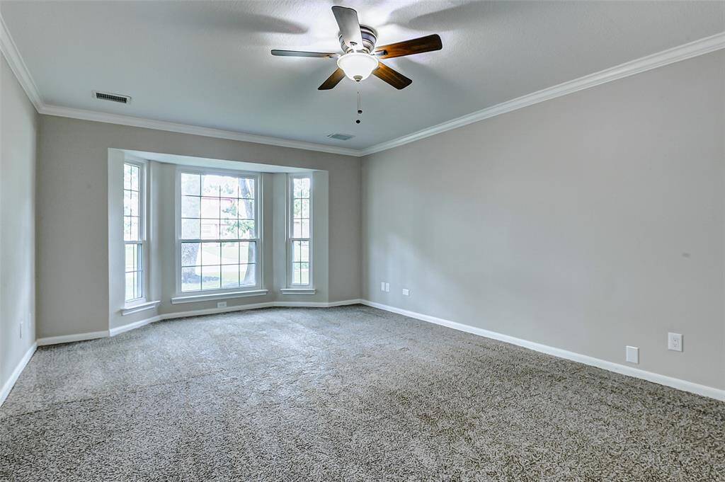 Large primary bedroom with new carpet and fresh paint.